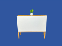 Back view of a nearly white console with a potted plant sitting on top.